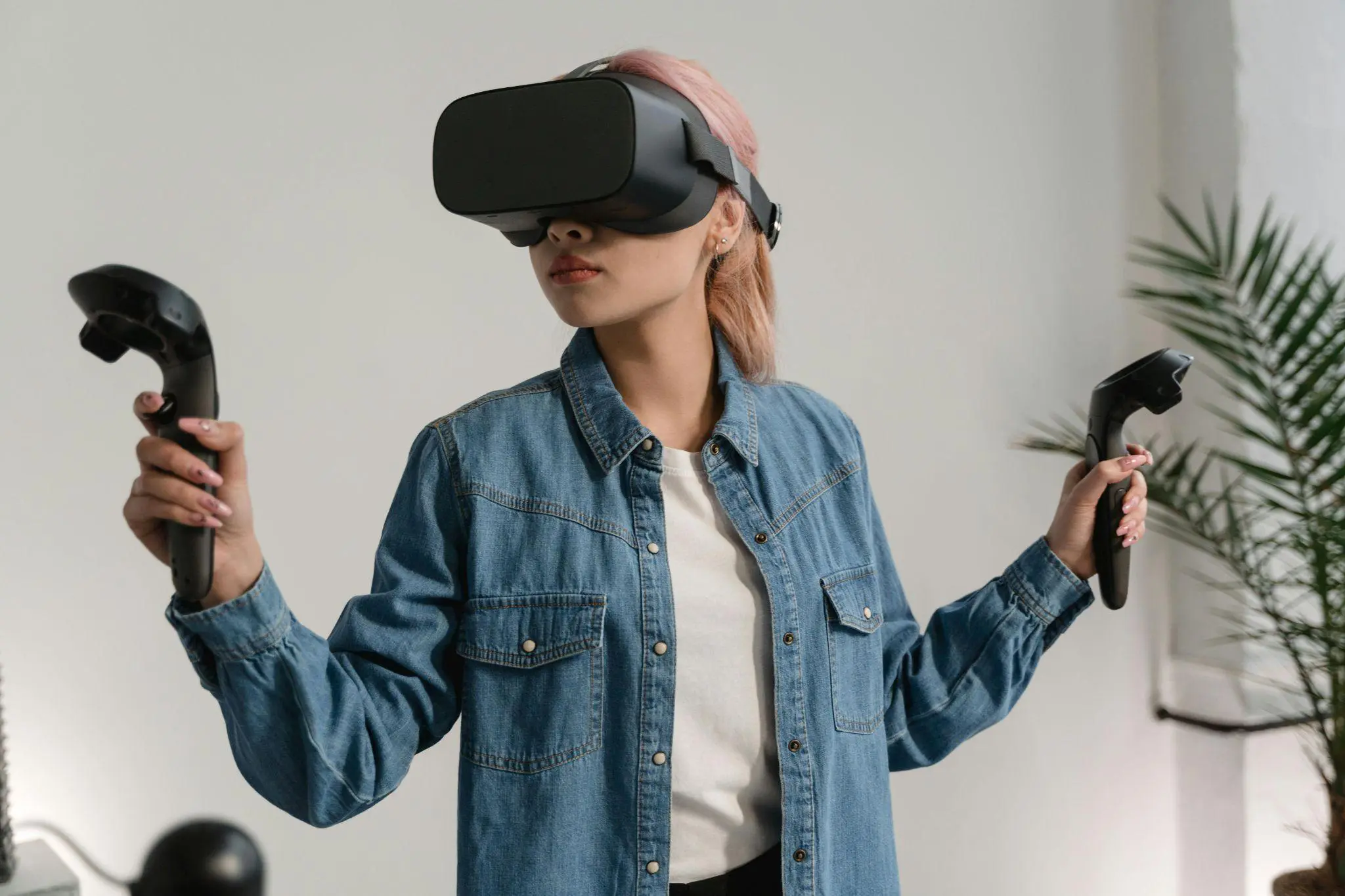 Woman experiencing VR with controllers